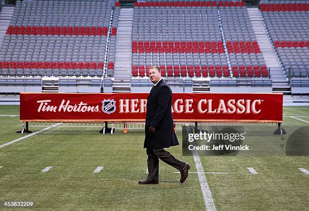 Mike Gillis, Vancouver Canucks President and General Manager, walks off the field after a media availability for the 2014 Tim Hortons NHL Heritage...