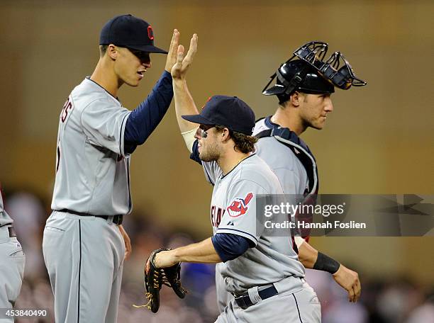 Zach Walters, Tyler Holt and Yan Gomes of the Cleveland Indians celebrate a win of the game against the Minnesota Twins on August 19, 2014 at Target...