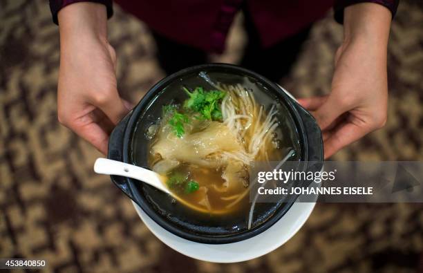 China-environment-social-food-economy,FOCUS by Felicia SONMEZ This photo taken on August 10, 2014 shows a waitress serving shark fin soup in a...