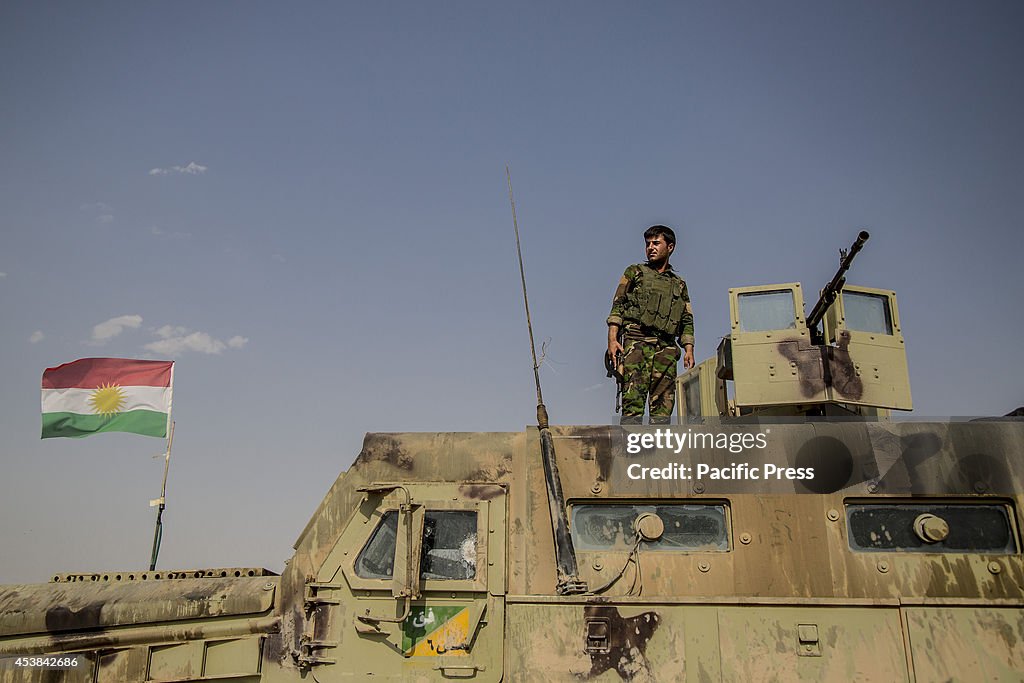 A Peshmerga soldier looks away from  the top of an American...