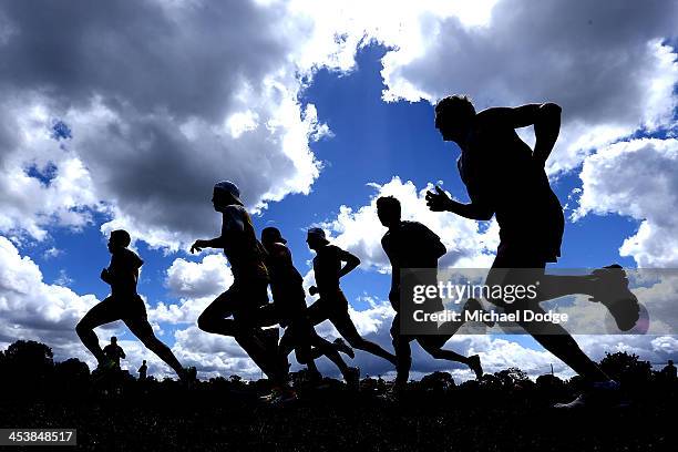 Players run laps during a Hawthorn Hawks training session at Box Hill City Oval on December 6, 2013 in Melbourne, Australia.