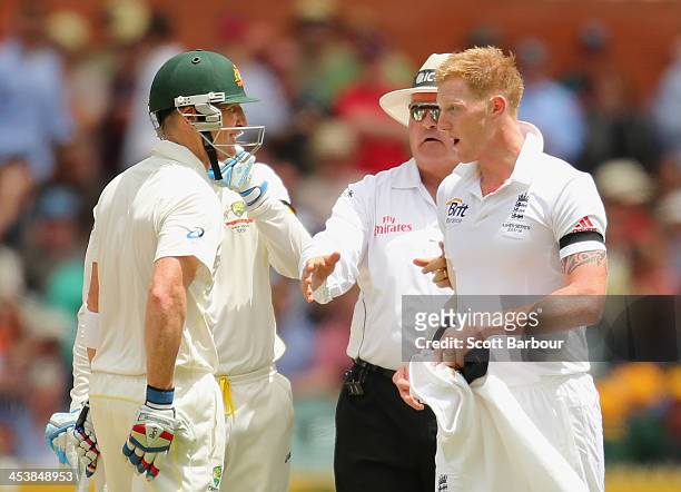 Brad Haddin of Australia and Ben Stokes of England exchange words as umpire Marais Erasmus steps between them during day two of the Second Ashes Test...