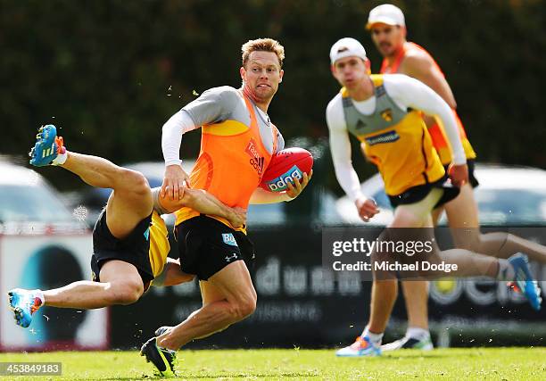 Paul Puopolo tackles Sam Mitchell during a Hawthorn Hawks training session at Box Hill City Oval on December 6, 2013 in Melbourne, Australia.