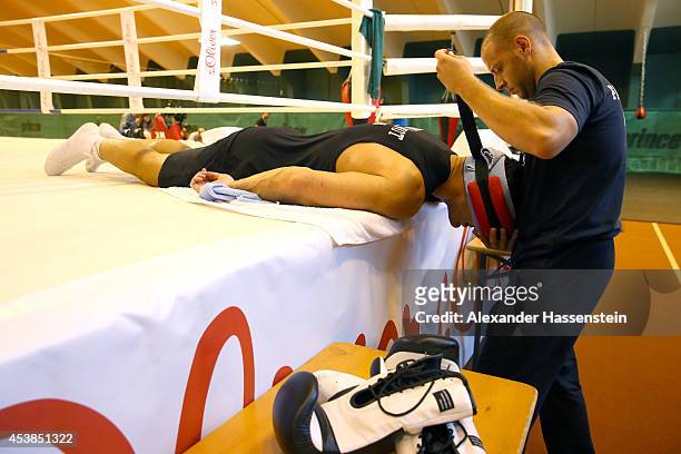 Aldo Vetere, Sports Therapist looks on with Wladimir Klitschko of Ukraine during a training session at Hotel Stanglwirt on August 19, 2014 in Going,...