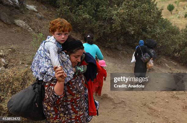 Some of the many thousands of Yezidis, who started to flee from Mount Sinjar in northern Iraq and Zakho city to the surrounding mountains across the...