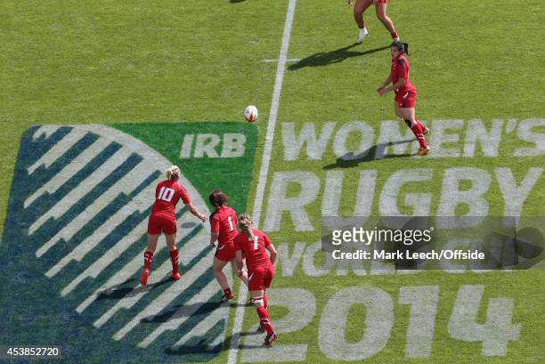 Play takes place over the IRB pitch logo as Wales pass the ball during the IRB Women's Rugby World Cup 2014 on August 13, 2014 in Paris, France.