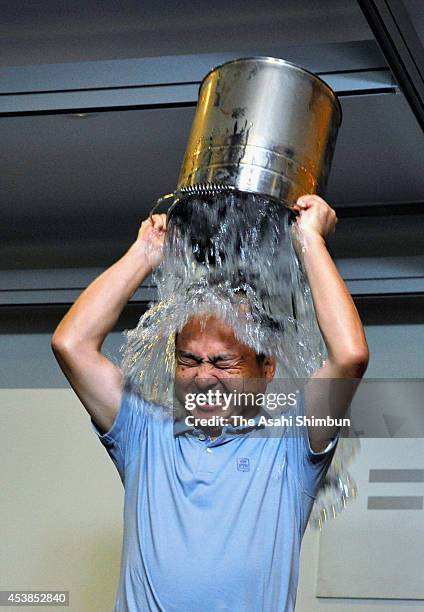 SoftBank CEO Masayoshi Son pours water for the Ice Bucket Challenge to raise awareness for amyotrophic lateral sclerosis on August 20, 2014 in Tokyo,...