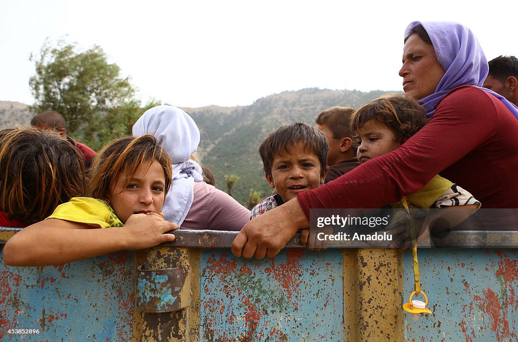 Iraqi Yezidis flee to surrounding mountains across the border into Turkey