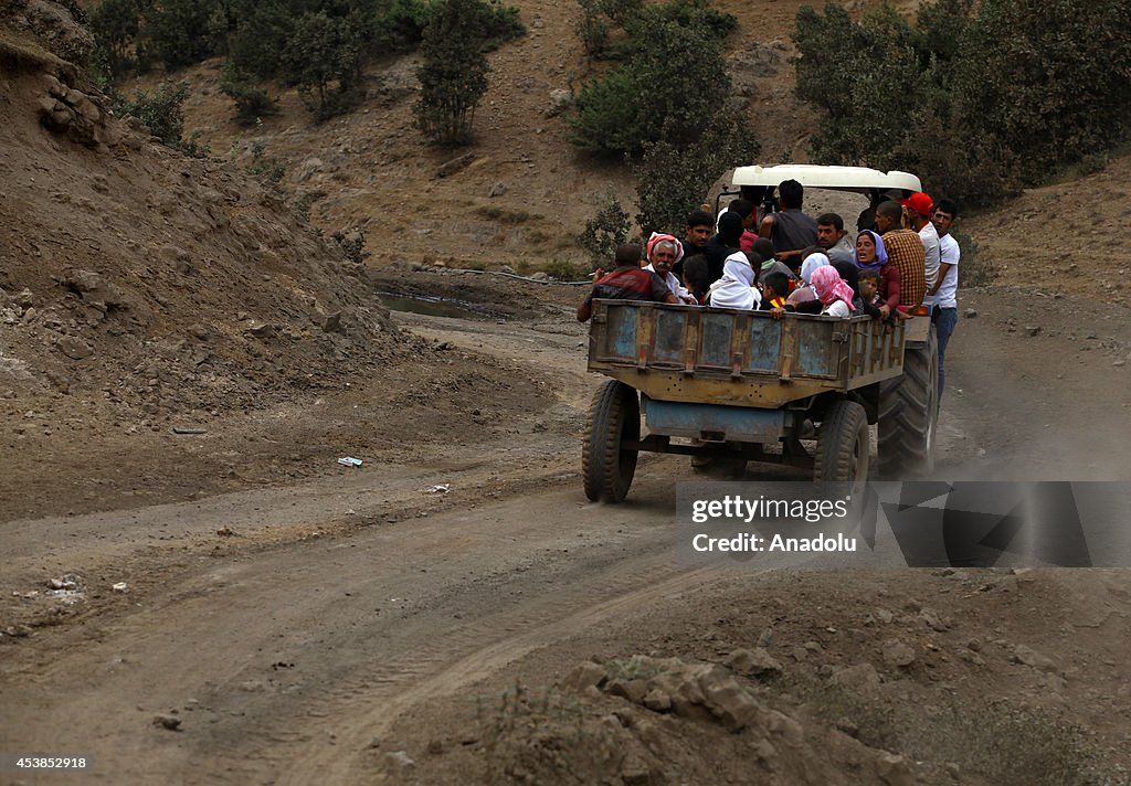 Iraqi Yezidis flee to surrounding mountains across the border into Turkey