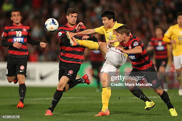 Sun Xiang of Evergrande clears the ball under pressure during the Asian Champions League Final match between the Western Sydney Wanderers and...