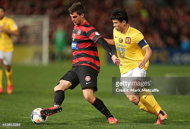 Tomi Juric of the Wanderers controls the ball under pressure from Sun Xiang of Evergrande during the Asian Champions League Final match between the...