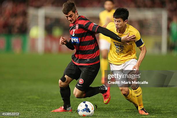 Tomi Juric of the Wanderers controls the ball under pressure from Sun Xiang of Evergrande during the Asian Champions League Final match between the...