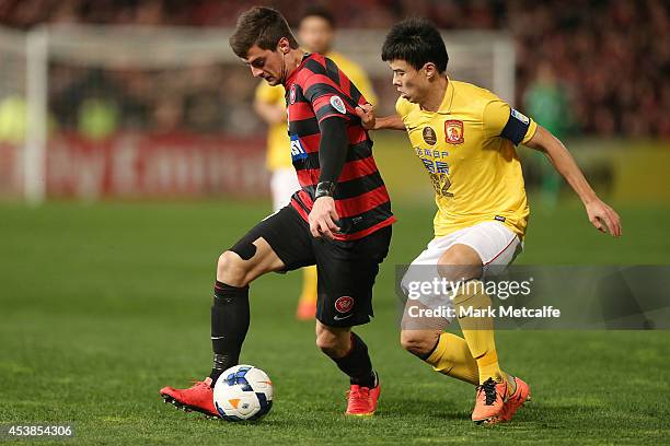 Tomi Juric of the Wanderers controls the ball under pressure from Sun Xiang of Evergrande during the Asian Champions League Final match between the...