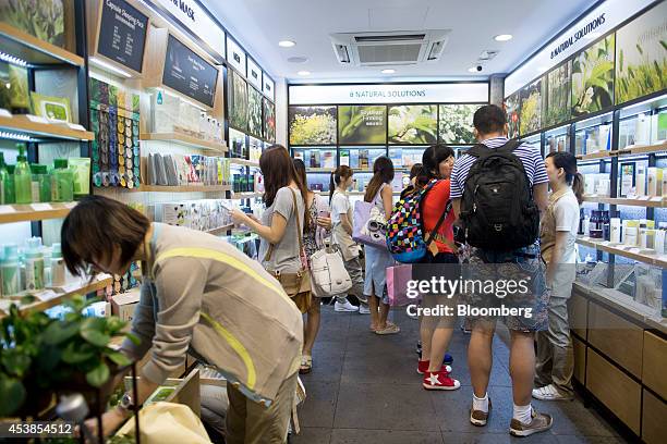Customers browse products at Amorepacific Corp.'s Innisfree store in the Causeway Bay district of Hong Kong, China, on Wednesday, Aug. 20, 2014....