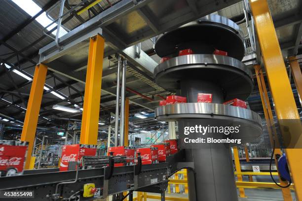 Boxes of Coca-Cola Classic move along a conveyor at a Coca-Cola Amatil Ltd. Production facility in Melbourne, Australia, on Tuesday, Aug. 19, 2014....