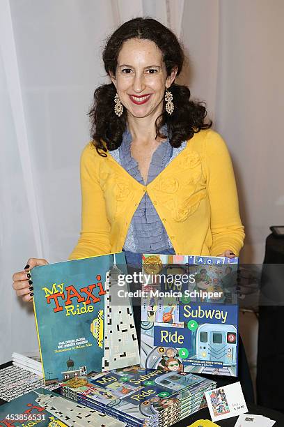 Illustrator Selina Alko poses with her work at "love art, give a smile" Art Fashion And Design Benefit at Clen Gallery on December 5, 2013 in New...