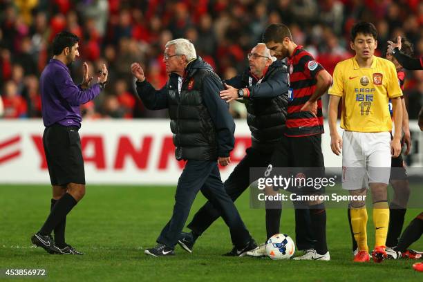 Evergrande coach Marcello Lippi marches onto the pitch during the Asian Champions League Final match between the Western Sydney Wanderers and...