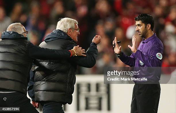 Evergrande coach Marcello Lippi remonstrates with the referee on the pitch following a red card given to Gao Lin of Evergrande during the Asian...