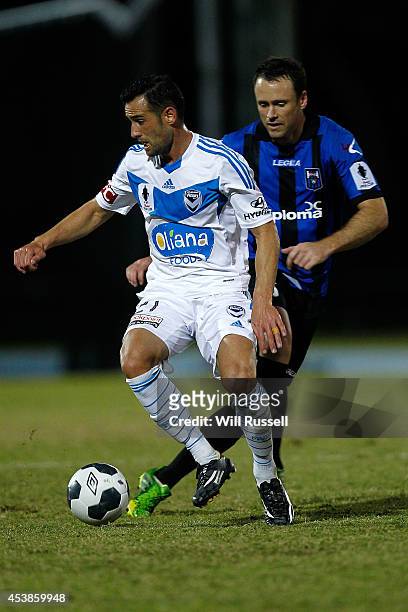 Carl Valeri of the Victory controls the ball under pressure from Todd Howarth of Bayswater City during the FFA Cup match between Bayswater City and...