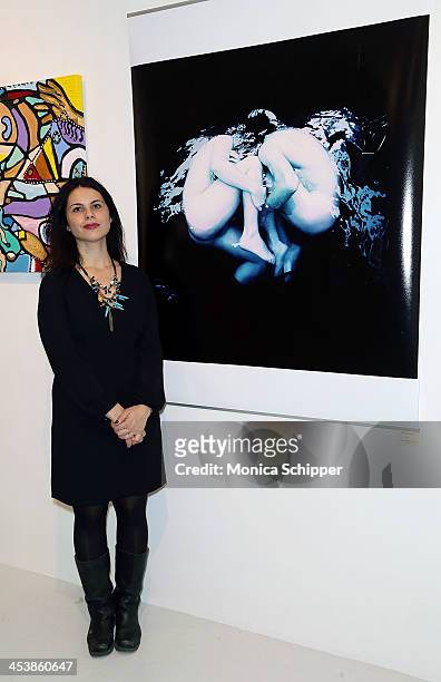Lourdes DeLa Cruz poses with her husband Francisco Uceda's work at "love art, give a smile" Art Fashion And Design Benefit at Clen Gallery on...