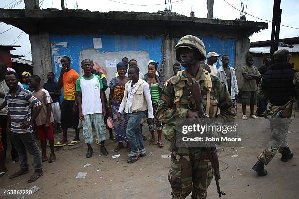 Members of Liberia's Ebola Task Force enforce a quarantine on the West Point slum on August 20, 2014 in Monrovia, Liberia. The government ordered the...