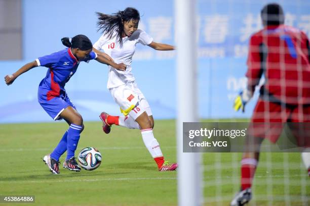 Tao Zhudan of China battles with Mbitjitandjambi Mungunda of Namibia in the Women's Football Preliminary Round Group B match between Namibia and...