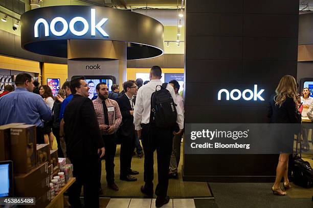 Attendees mingle during the launch event for the new Samsung Galaxy Tab 4 Nook at a Barnes & Noble store in New York, U.S., on Wednesday, Aug. 20,...