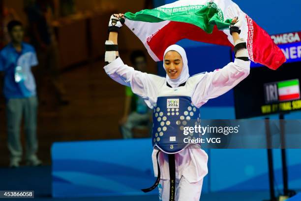 Kimia Alizadeh Zenoorin of Iran celebrates after beating Yulia Turutina of Russia in the Taekwondo Women's -63kg final match on day four of the...