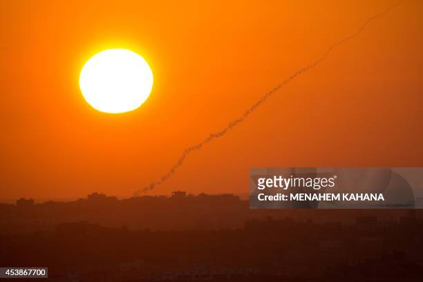 Picture taken from the Israeli side of the Israel-Gaza Border on August 20 shows the smoke trail of a rocket fired by Palestinian militants from the...