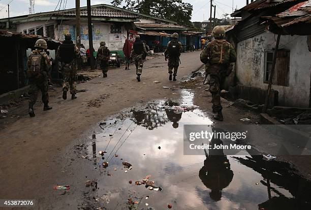 Liberian security forces, part of the country's Ebola Task Force, enforce a quarantine on the West Point slum on August 20, 2014 in Monrovia,...