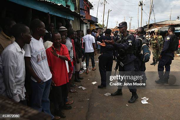 Liberian security forces, part of the country's Ebola Task Force, enforce a quarantine on the West Point slum on August 20, 2014 in Monrovia,...