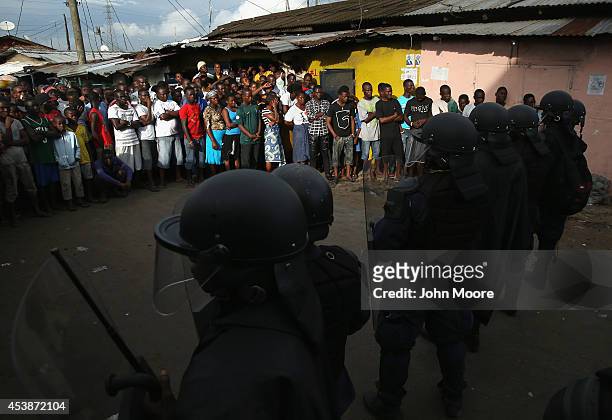 Liberian security forces, part of the country's Ebola Task Force, enforce a quarantine on the West Point slum on August 20, 2014 in Monrovia,...