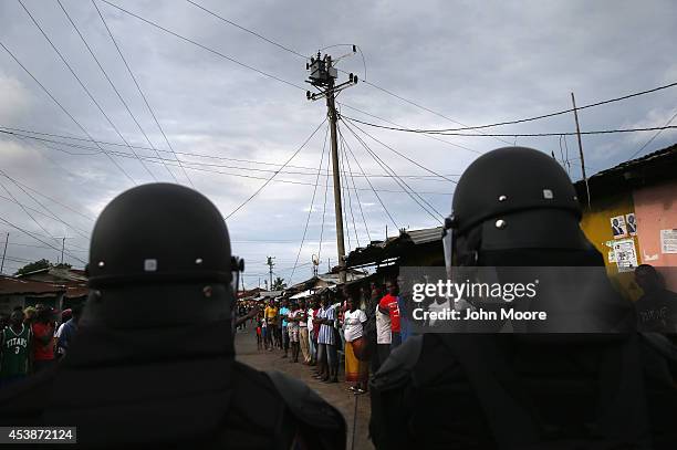 Liberian security forces, part of the country's Ebola Task Force, enforce a quarantine on the West Point slum on August 20, 2014 in Monrovia,...