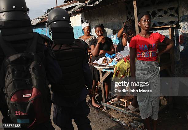 Liberian security forces, part of the country's Ebola Task Force, enforce a quarantine on the West Point slum on August 20, 2014 in Monrovia,...