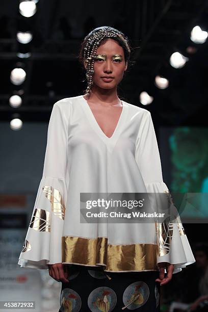 Model showcases designs by Masaba during the Opening Day show as part of Lakme Fashion Week Winter/Festive 2014 at The Palladium Hotel on August 19,...