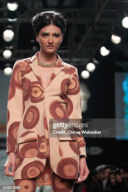 Model showcases designs by Masaba during the Opening Day show as part of Lakme Fashion Week Winter/Festive 2014 at The Palladium Hotel on August 19,...