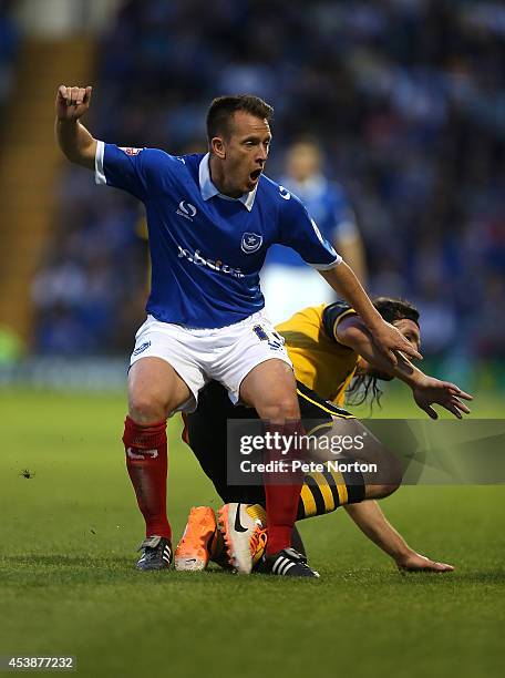 Nicky Shorey of Portsmouth clashes with John-Joe O'Toole of Northampton Town during the Sky Bet League Two match between Portsmouth and Northampton...