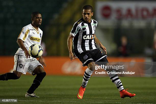 Clayton of Figueirense takes the ball with Junior Cesar of Botafogo behind him during a match between Figueirense and Botafogo as part of Campeonato...