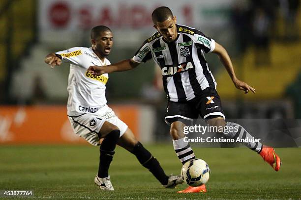 Clayton of Figueirense takes the ball with Junior Cesar of Botafogo behind him during a match between Figueirense and Botafogo as part of Campeonato...