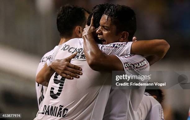 Leandro Damiao of Santos celebrates scoring the first goal with David Braz during the match between Santos and Atletico PR for the Brazilian Series A...
