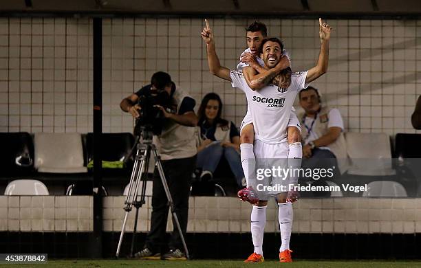 Thiago Ribeiro of Santos celebrates scoring the first goal with Rildo during the match between Santos and Atletico PR for the Brazilian Series A 2014...