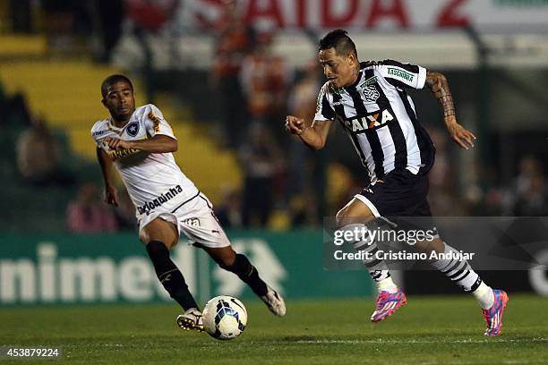Junior Cesar of Botafogo moves the ball against Giovanni Augusto of Figueirense during a match between Figueirense and Botafogo as part of Campeonato...