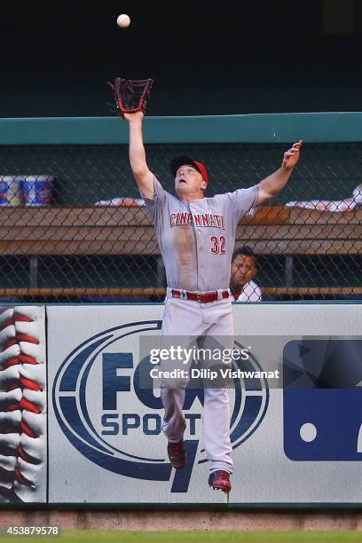 Jay Bruce of the Cincinnati Reds catches a deep fly ball against the St. Louis Cardinals in the third inning at Busch Stadium on August 20, 2014 in...