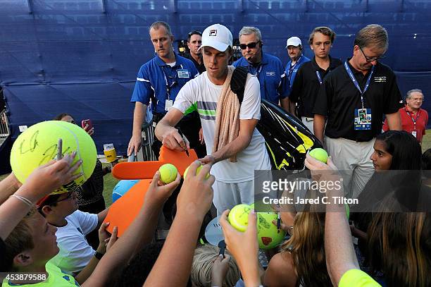 Sam Querrey signs autographs for fans after defeating Kevin Anderson of South Africa during the Winston-Salem Open at Wake Forest University on...