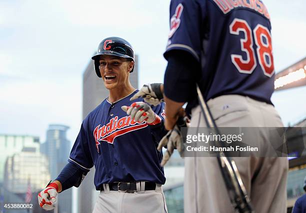 Chris Dickerson of the Cleveland Indians congratulates teammate Zach Walters on his solo home run against the Minnesota Twins during the second...