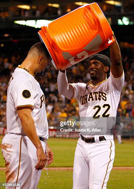 Andrew McCutchen of the Pittsburgh Pirates dumps Gatorade on Gaby Sanchez after hitting a walk off sacrifice fly in the ninth inning against the...