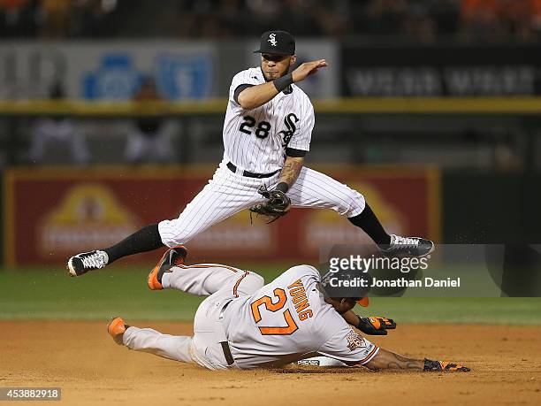 Leury Garcia of the Chicago White Sox leaps over Delmon Young of the Baltimore Orioles to turn a double play in the 8th inning at U.S. Cellular Field...