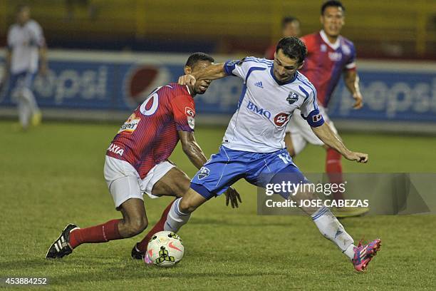 Elder Figueroa of C.D. Fas of El Salvador vies the ball against Dilly Duka of the Montreal Impact during their match for the CONCACAF Champions...