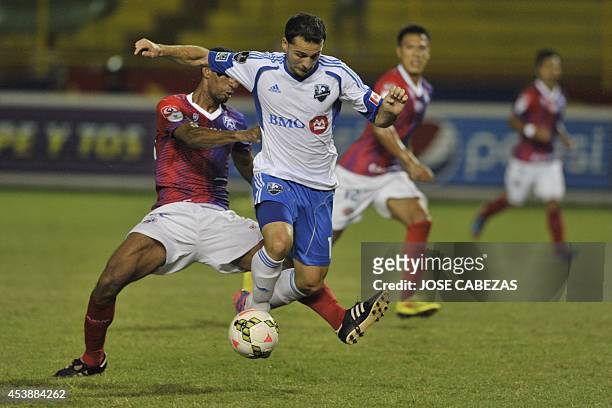 Elder Figueroa of C.D. Fas of El Salvador vies the ball against Dilly Duka of the Montreal Impact during their match for the CONCACAF Champions...