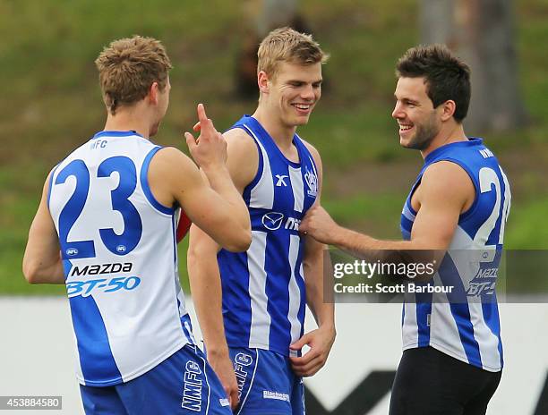 Kieran Harper, Mason Wood and Levi Greenwood look on during a North Melbourne Kangaroos AFL training session at Arden Street Ground on August 21,...